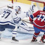 
              Toronto Maple Leafs goaltender Petr Mrazek, center, makes a save against Montreal Canadiens' Josh Anderson, right, as Maple Leafs' Timothy Liljegren, left, defends during second-period NHL hockey game action in Montreal, Monday, Feb. 21, 2022. (Graham Hughes/The Canadian Press via AP)
            