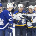 
              St. Louis Blues' Pavel Buchnevich, center, celebrates with teammates after scoring as Toronto Maple Leafs' Jake Muzzin, left, skates past during first-period NHL hockey game action in Toronto, Saturday, Feb. 19, 2022. (Chris Young/The Canadian Press via AP)
            