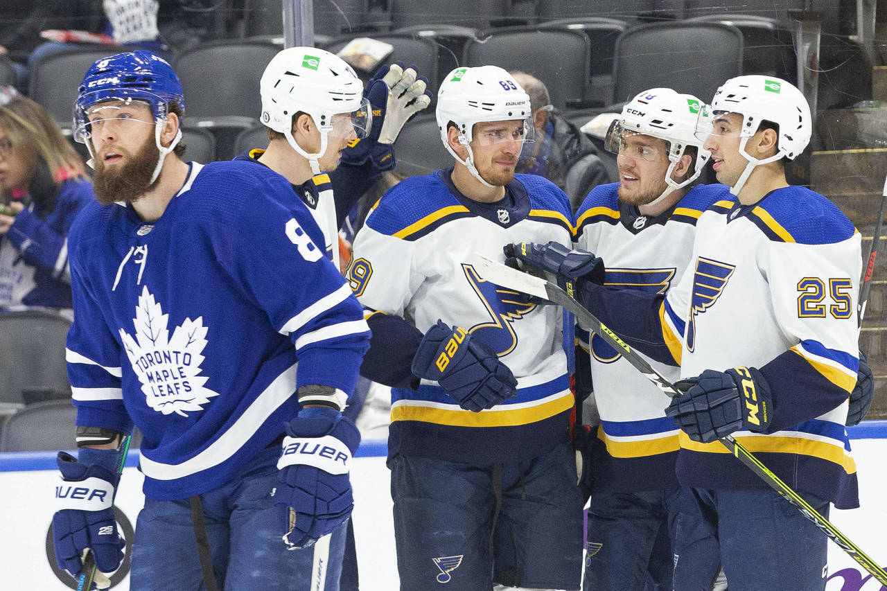 St. Louis Blues' Pavel Buchnevich, center, celebrates with teammates after scoring as Toronto Maple...
