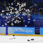
              White papers are tossed in the air near Finland coaches after defeating the Russian Olympic Committee in the men's gold medal hockey game at the 2022 Winter Olympics, Sunday, Feb. 20, 2022, in Beijing. (AP Photo/Petr David Josek)
            