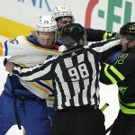 
              Linesman Dan Kelly (98) tries to break up Buffalo Sabres Rasmus Dahlin (26), Tage Thompson (72) and Dallas Stars Riley Tufte (27) during the second period of an NHL hockey game in Dallas, Sunday, Feb. 27, 2022. (AP Photo/LM Otero)
            