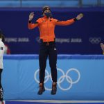 
              Suzanne Schulting of the Netherlands, celebrates on the podium after winning the final of the women's 1000-meters during the short track speedskating competition at the 2022 Winter Olympics, Friday, Feb. 11, 2022, in Beijing. (AP Photo/Natacha Pisarenko)
            