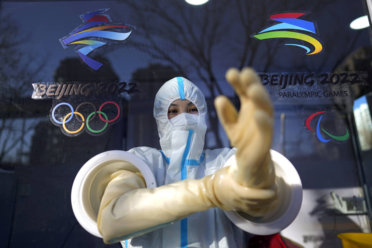 A worker prepares to administer a COVID-19 test at the 2022 Winter Olympics, Tuesday, Feb. 1, 2022,...
