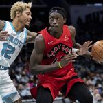 
              Charlotte Hornets guard Kelly Oubre Jr. (12) tries to knock the ball away from Toronto Raptors forward Pascal Siakam (43) during the second half of an NBA basketball game in Charlotte, N.C., Monday, Feb. 7, 2022. (AP Photo/Jacob Kupferman)
            