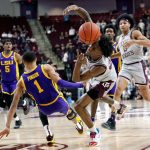 
              Texas A&M guard Quenton Jackson (3) lis fouled by LSU guard Xavier Pinson (1) on a fast break during the second half of an NCAA college basketball game Tuesday, Feb. 8, 2022, in College Station, Texas. (AP Photo/Sam Craft)
            