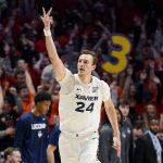
              Xavier forward Jack Nunge (24) reacts after making a 3-point basket during the first half of the team's NCAA college basketball game against Connecticut, Friday, Feb. 11, 2022, in Cincinnati. (AP Photo/Jeff Dean)
            
