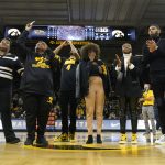 
              The family of former Iowa player Roy Marble react on the court during his jersey retirement ceremony before an NCAA college basketball game between Iowa and Michigan State, Tuesday, Feb. 22, 2022, in Iowa City, Iowa. (AP Photo/Charlie Neibergall)
            