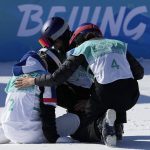 
              Silver medalist, left, Tess Ledeux, of France, is comforted by gold medalist, right, Eileen Gu, of China, and bronze medalist Mathilde Gremaud of Switzerland after the women's freestyle skiing big air finals of the 2022 Winter Olympics, Tuesday, Feb. 8, 2022, in Beijing. (AP Photo/Jae C. Hong)
            