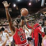 
              FILE - The Chicago Bulls Michael Jordan celebrates after the Bulls beat the Phoenix Suns 99-98 to win their third consecutive NBA title in Phoenix, June 20, 1993. (AP Photo/John Swart, File)
            