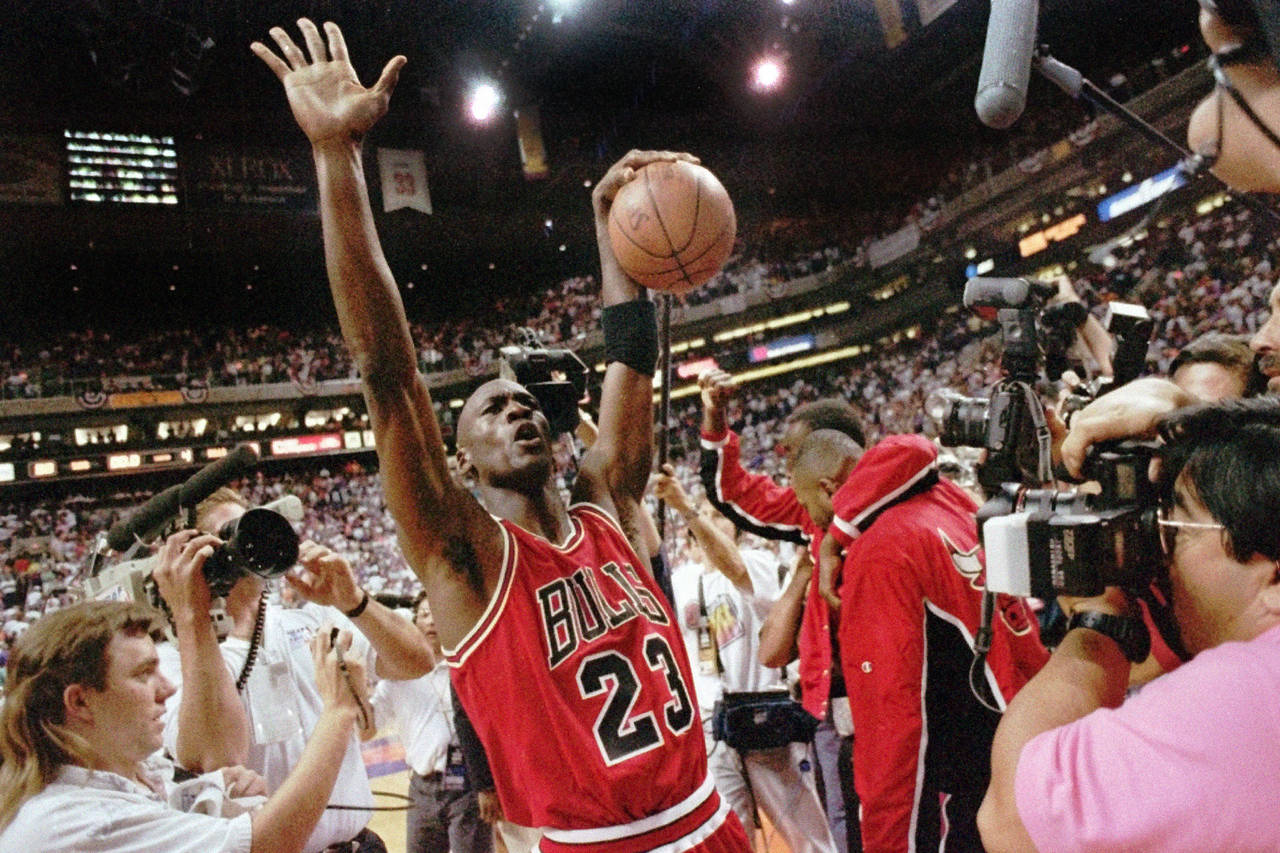 FILE - The Chicago Bulls Michael Jordan celebrates after the Bulls beat the Phoenix Suns 99-98 to w...