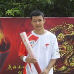
              In this photo provided by Kamaltürk Yalqun, Yalqun holds the Olympic torch after running the torch relay for the 2008 Beijing Olympics on July 30, 2008, in Qinhuangdao, China. The decade after the Games saw Beijing impose policies on his region of Xinjiang that split apart his family and Uyghur community. Today, he is an activist in the United States calling for a boycott of the 2022 Winter Games, which will see the Olympic flame returned to Beijing. (Kamaltürk Yalqun via AP)
            