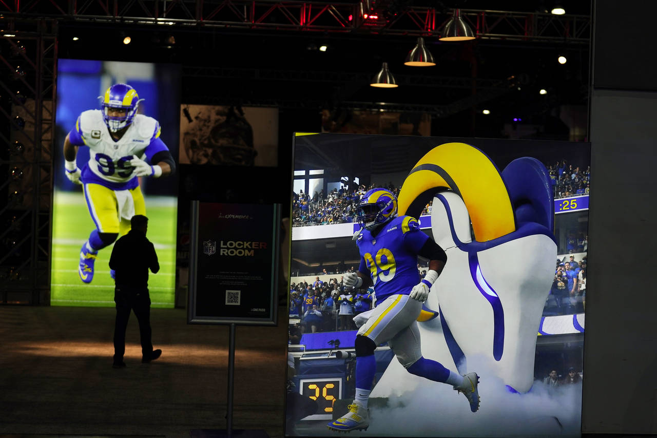 Images of Los Angeles Rams defensive end Aaron Donald are displayed inside the NFL Experience, an i...