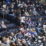 
              Winnipeg Jets fans watch during the first period of the team's NHL hockey game against the Minnesota Wild, as attendance caps were lifted, Wednesday, Feb. 16, 2022, in Winnipeg, Manitoba. (John Woods/The Canadian Press via AP)
            
