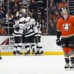 
              Los Angeles Kings celebrate a goal by Adrian Kempe as Anaheim Ducks' Simon Benoit, foreground, looks at a display during the second period of an NHL hockey game Friday, Feb. 25, 2022, in Anaheim, Calif. (AP Photo/Jae C. Hong)
            