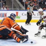 
              Chicago Blackhawks' Patrick Kane (88) is stopped by Edmonton Oilers goalie Mike Smith (41) during the third period of an NHL hockey game Wednesday, Feb. 9, 2022, in Edmonton, Alberta. (Jason Franson/The Canadian Press via AP)
            