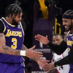 
              Los Angeles Lakers forward Anthony Davis, left, celebrates with forward Carmelo Anthony after scoring during the second half of an NBA basketball game against the Portland Trail Blazers Wednesday, Feb. 2, 2022, in Los Angeles. (AP Photo/Mark J. Terrill)
            