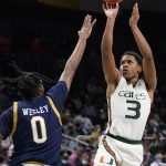 
              Miami guard Charlie Moore (3) takes a shot against Notre Dame guard Blake Wesley (0) during the second half of an NCAA college basketball game, Wednesday, Feb. 2, 2022, in Coral Gables, Fla. (AP Photo/Wilfredo Lee)
            