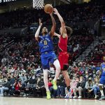 
              Denver Nuggets guard Monte Morris, left, shoots over Portland Trail Blazers guard CJ Elleby during the second half of an NBA basketball game in Portland, Ore., Sunday, Feb. 27, 2022. (AP Photo/Craig Mitchelldyer)
            