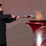 
              Chinese Vice Premier Han Zheng lights the torch before the start of the torch relay for the 2022 Winter Olympics at the Olympic Forest Park in Beijing on Wednesday, Feb. 2, 2022. (AP Photo/Sam McNeil)
            