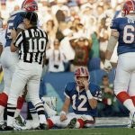 
              FILE - Buffalo Bills quarterback Jim Kelly (12) sits on the field after fumbling the ball in the first quarter and giving up a touchdown to Dallas Cowboys defender Jimmie Jones during NFL football's Super Bowl XXVII in Pasadena, Calif., Jan. 31, 1993. Cowboys defender Charles Haley forced the fumble that Jones took in for the score. (AP Photo/Eric Risberg, File)
            