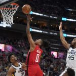 
              Houston Rockets guard Jalen Green (0) goes to the basket as Utah Jazz's Hassan Whiteside (21) and Donovan Mitchell (45) defend during the first half of an NBA basketball game Monday, Feb. 14, 2022, in Salt Lake City. (AP Photo/Rick Bowmer)
            