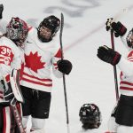 
              Canada goalkeeper Ann-Renee Desbiens (35) celebrates with Emily Clark (26) and Jamie Lee Rattray (47) after a 10-3 win over Switzerland in a women's semifinal hockey game at the 2022 Winter Olympics, Monday, Feb. 14, 2022, in Beijing. (AP Photo/Petr David Josek)
            
