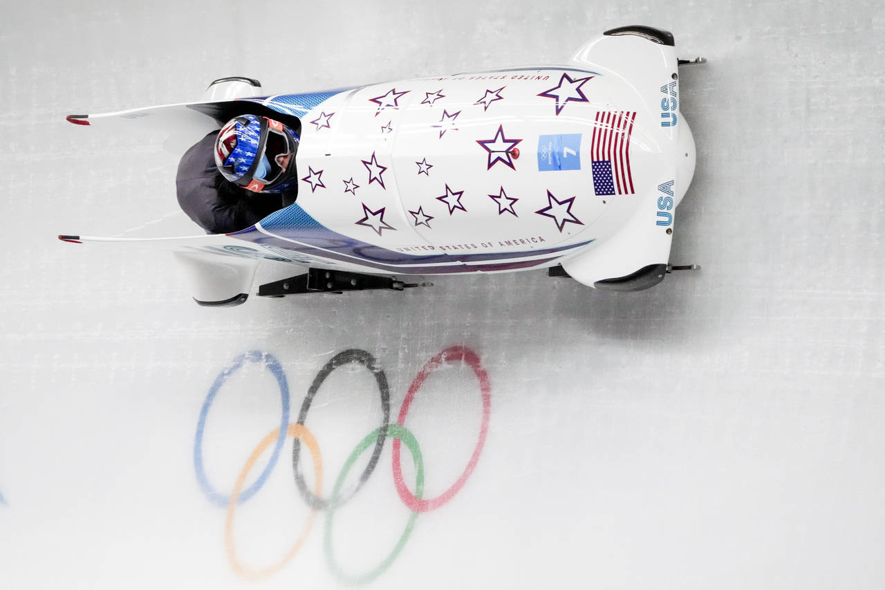 Kaillie Humphries and Kaysha Love, of the United States, slide during the women's bobsleigh heat 1 ...