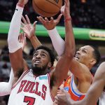 
              Chicago Bulls forward Troy Brown Jr., left, battles for a rebound against Oklahoma City Thunder forward Darius Bazley during the first half of an NBA basketball game in Chicago, Saturday, Feb. 12, 2022. (AP Photo/Nam Y. Huh)
            