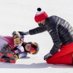 
              Nina O'Brien lies on the track after falling during the women's giant slalom at the 2022 Winter Olympics, Monday, Feb. 7, 2022, in the Yanqing district of Beijing.(AP Photo/Mark Schiefelbein)
            