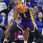 
              LSU's Xavier Pinson (1) looks for an opening as Kentucky's Davion Mintz, rear, defends during the second half of an NCAA college basketball game in Lexington, Ky., Wednesday, Feb. 23, 2022. (AP Photo/James Crisp)
            
