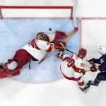 
              United States' Brian Oneill (21) scores past China goalkeeper Jieruimi Shimisi (Jeremy Smith) (45) and China's Dannisi Aoxibofu (Denis Osipov) (60) during a preliminary round men's hockey game at the 2022 Winter Olympics, Thursday, Feb. 10, 2022, in Beijing. (AP Photo/Matt Slocum)
            