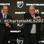 
              FILE - MLS Commissioner Don Garber, left, and Charlotte MLS owner David Tepper announce that Major League Soccer will be coming to Charlotte in 2021 at an event in Charlotte, N.C., Tuesday, Dec. 17, 2019. Expansion Charlotte FC opens its inaugural season on Saturday, Feb. 26, 2022, against D.C. United at Audi Field.(AP Photo/Nell Redmond, File)
            