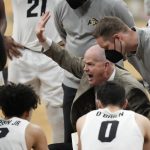 
              Colorado head coach Tad Boyle, center, confers with players during a timeout in the second half of an NCAA college basketball game against Utah, Saturday, Feb. 12, 2022, in Boulder, Colo. (AP Photo/David Zalubowski)
            
