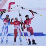 
              Beat Feuz, of Switzerland, gold, center, Johan Clarey, of France, silver, left, and Matthias Mayer, of Austria, bronze, react during the medal ceremony for the men's downhill at the 2022 Winter Olympics, Monday, Feb. 7, 2022, in the Yanqing district of Beijing.(AP Photo/Luca Bruno)
            