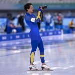 
              Nils van der Poel of Sweden takes photographs after winning the gold medal and setting an Olympic record in the men's speedskating 5,000-meter race at the 2022 Winter Olympics, Sunday, Feb. 6, 2022, in Beijing.  (Paul Chiasson/The Canadian Press via AP)
            