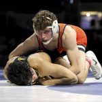 
              Trevor Mastrogiovanni, top, of Oklahoma State, pins Jesse Ybarra, of Iowa, during the Bout at the Ballpark wrestling event Saturday, Feb. 12, 2022, at Globe Life Field in Arlington, Texas. (Steve Nurenberg/The Dallas Morning News via AP)
            