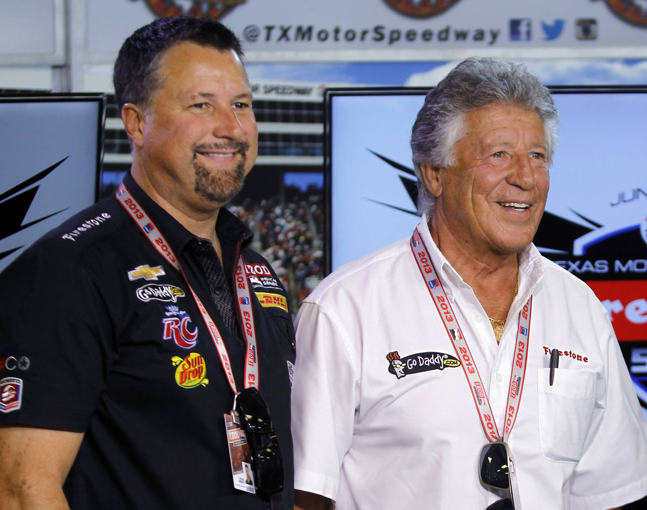 FILE - In this June 7, 2013, photo, Michael Andretti, left, and his father, Mario Andretti, pose fo...