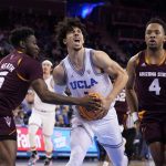 
              UCLA guard Jules Bernard, center, is fouled by Arizona State guard Jay Heath, left, during the first half of an NCAA college basketball game Monday, Feb. 21, 2022, in Los Angeles. (AP Photo/Marcio Jose Sanchez)
            