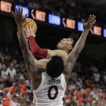 
              Alabama guard Jahvon Quinerly is fouled by Auburn guard K.D. Johnson (0) during the first half of an NCAA college basketball game Tuesday, Feb. 1, 2022, in Auburn, Ala. (AP Photo/Butch Dill)
            