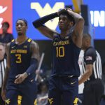 
              West Virginia guard Malik Curry (10) reacts after missing the final shot against Texas during the second half of an NCAA college basketball game in Morgantown, W.Va., Saturday, Feb. 26, 2022. (AP Photo/Kathleen Batten)
            