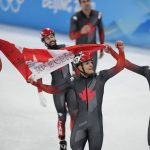 
              Team Canada celebrate after winning the men's 5000-meters relay final during the short track speedskating competition at the 2022 Winter Olympics, Wednesday, Feb. 16, 2022, in Beijing. (AP Photo/David J. Phillip)
            