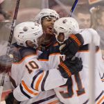 
              Edmonton Oilers center Derek Ryan (10) celebrates his third goal of the day with defenseman Darnell Nurse, center, and left wing Evander Kane (91) during the second period of an NHL hockey game against the Florida Panthers, Saturday, Feb. 26, 2022, in Sunrise, Fla. (AP Photo/Wilfredo Lee)
            