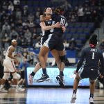 
              Villanova's Brianna Herlihy and Villanova's Christina Dalce (10) embrace in the air as they celebrate their team's win in an NCAA college basketball game against Connecticut, Wednesday, Feb. 9, 2022, in Hartford, Conn. (AP Photo/Jessica Hill)
            