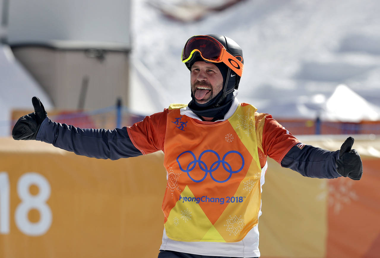 FILE - Nick Baumgartner, of the United States, celebrates after his run during the men's snowboard...