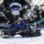
              Canada's Marie-Philip Poulin (29) scores against United States goalkeeper Maddie Rooney (35) on a penalty shot during a preliminary round women's hockey game at the 2022 Winter Olympics, Tuesday, Feb. 8, 2022, in Beijing. (Song Yanhua/Pool Photo via AP)
            