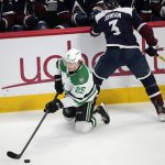 
              Dallas Stars left wing Joel Kiviranta, left, reaches out to control the puck next to Colorado Avalanche defenseman Jack Johnson during the third period of an NHL hockey game Tuesday, Feb. 15, 2022, in Denver. The Stars won 4-1. (AP Photo/David Zalubowski)
            