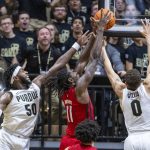 
              Purdue forwards Trevion Williams (50) and Mason Gillis (0) battle for a rebound with Rutgers center Clifford Omoruyi (11) during the first half of an NCAA college basketball game, Sunday, Feb. 20, 2022, in West Lafayette, Ind. (AP Photo/Doug McSchooler)
            