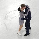 
              Madison Chock and Evan Bates, of the United States, kiss after completing their routine in the team ice dance program during the figure skating competition at the 2022 Winter Olympics, Monday, Feb. 7, 2022, in Beijing. (AP Photo/Jeff Roberson)
            