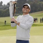 
              Joaquin Niemann, of Chile, reacts with his trophy on the 18th green after winning the Genesis Invitational golf tournament at Riviera Country Club, Sunday, Feb. 20, 2022, in the Pacific Palisades area of Los Angeles. (AP Photo/Ryan Kang)
            