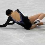 
              Karen Chen, of the United States, falls in the women's short program team figure skating competition at the 2022 Winter Olympics, Sunday, Feb. 6, 2022, in Beijing. (AP Photo/David J. Phillip)
            